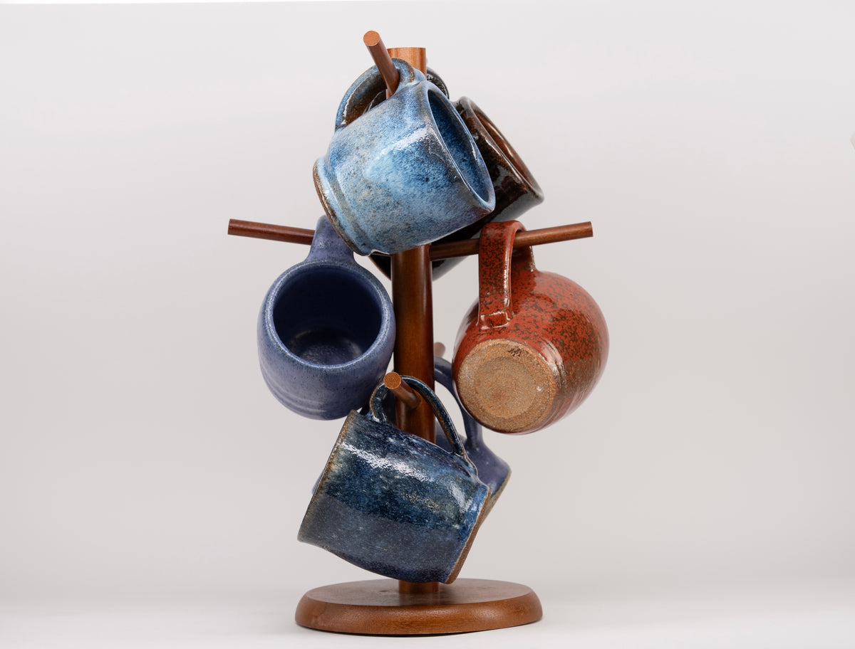 Hands shaping clay on potter's wheel